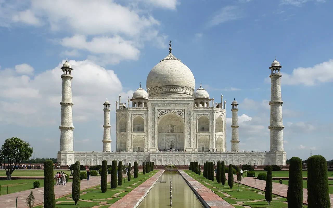 The Taj Mahal and its minarets beyond a formal garden